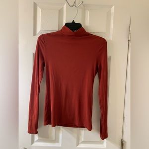 Woman’s burnt orange mock top long sleeve shirt